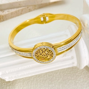 Detail of gold tree of life bangle with white rhinestones and spring clasp mechanism