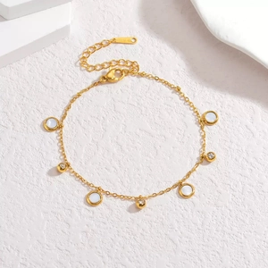 Elegant gold stainless steel necklace featuring white shell charms and zircon spheres