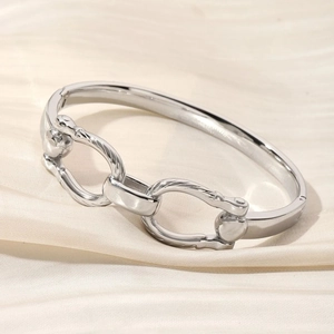 Polished silver stainless steel bangle featuring a stylish double-ring horsebit buckle design