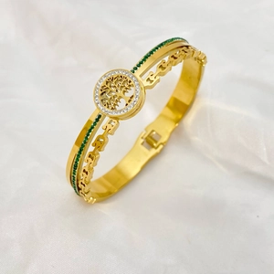 Detail showing Tree of Life charm with white zircon ring and green gemstone band