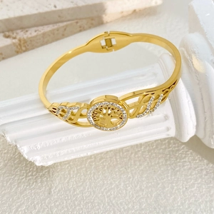 Gold stainless steel Tree of Life bangle with sparkling rhinestones and openwork wings