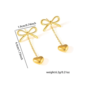 Detailed size view of gold bow earrings with heart pendants and measurement labels