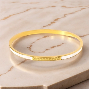 Golden stainless steel bangle featuring white shell inlay and classic Greek key pattern
