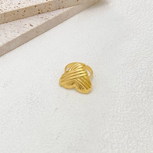 Detailed close-up of a gold ripple texture adjustable open ring with a vintage finish
