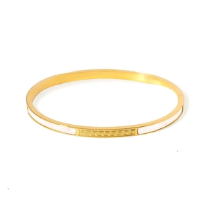 Golden stainless steel bangle with white shell inlay and Greek key pattern design