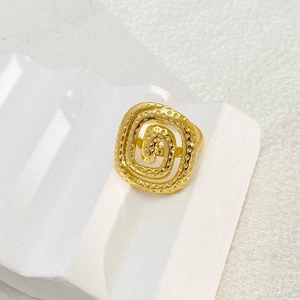 Detailed view of adjustable gold-plated square spiral ring with textured hammered finish
