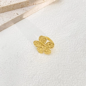 Macro shot of gold floral adjustable ring with textured organic petals and hammered finish