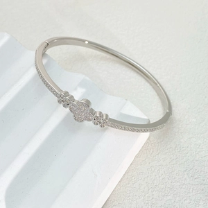Minimalist silver clover bangle with micro-pave zirconia in a stylish open design