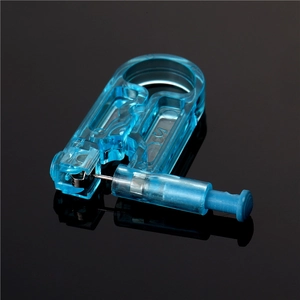 Sterile disposable ear piercing gun in blue clear plastic with silver stud and OC5 mark