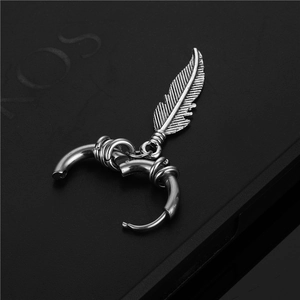 Retro stainless steel hoop earring with a detailed feather pendant on black background