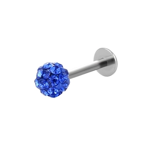 Detailed shot of a surgical steel labret stud with a blue crystal pavé ball top