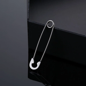 Macro shot of silver stainless steel safety pin earring with high reflective finish