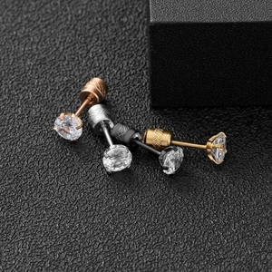Macro view of four-prong round zircon earrings with screw-back in multiple metallic finishes