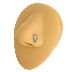 Detailed close-up of a lizard-shaped nose stud with shimmering cubic zirconia stones