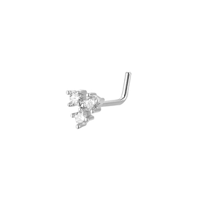 Détail macro d'un piercing de nez en L avec trois pierres de zircone scintillantes