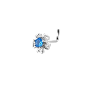 Macro shot of L-shaped nose stud with heart petal flower design and blue zircon inlay