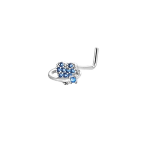Macro detail of L-shaped nose stud featuring blue zircon heart planet in silver metal