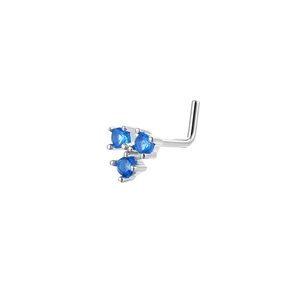 Close-up of L-shaped nose stud with three blue cubic zirconia in a triangle setting