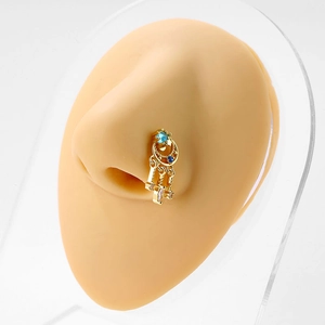 Golden moon and star L-shaped nose stud with blue zircon tassels on a model