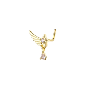 Close-up of golden L-shaped nose stud with winged star and teardrop zircon pendant