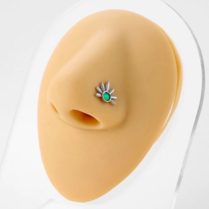 Sexy 20G L-shaped silver nose stud featuring a radiant green oval gemstone on a nose model