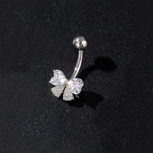 Detailed close-up of a silver butterfly navel ring with inlaid heart-shaped cubic zirconia