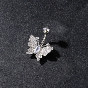 Macro detail of butterfly navel ring with silver finish and sparkling zircon stones