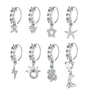 Λεπτομέρεια από 8 ασημένια piercing δαχτυλίδια με σχέδια πεταλούδα, αστέρι και ζιργκόν