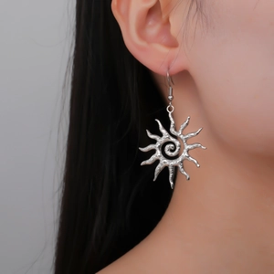 Spiral sun pendant earrings in silver stainless steel with hammer texture on model