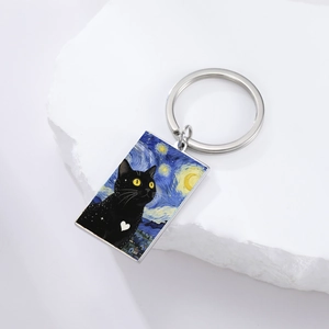Starry night style rectangle keychain with black cat illustration on stone surface