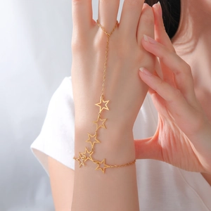 Detailed close-up of golden star-shaped hand harness chain with cutout star charms