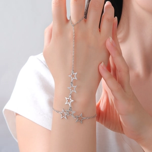 Detailed close-up of a silver star charm hand harness bracelet with minimalist ring link