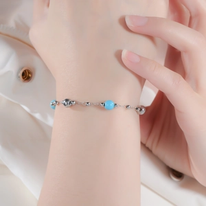 Bohemian style silver stainless steel bracelet with light blue turquoise beads on wrist