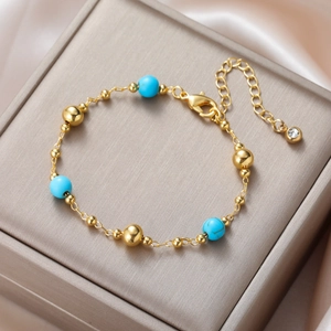 Detail of bohemian turquoise beaded bracelet on champagne silk with zircon charm