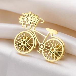 Golden flower bicycle brooch in stainless steel with hollow design on white silk fabric