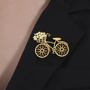 Creative bicycle flower brooch in gold finish pinned on a black suit lapel for men and women