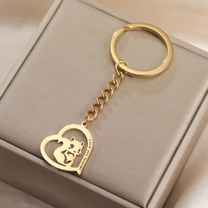 Macro shot of gold heart keychain with cat silhouette and Love you forever engraving