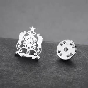 Moroccan national emblem brooch in silver stainless steel on textured stone background