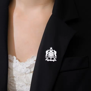 Moroccan style white cutout brooch made of 304 stainless steel on a black suit lapel