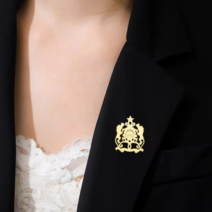 Golden Moroccan coat of arms brooch with crown and star on elegant black suit lapel