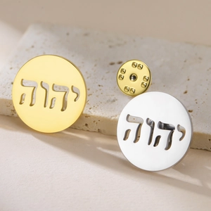 Macro detail of hexagram yoga brooches in gold and silver finish on stone base