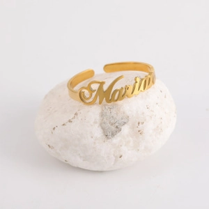 Macro shot of custom name ring Maria in gold finish with an adjustable band