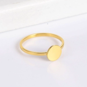 Detailed side view of a minimalist gold stainless steel ring with a flat circular disc