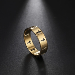 Detailaufnahme des polierten goldenen Edelstahlrings mit hohlem Kreuzmuster-Design