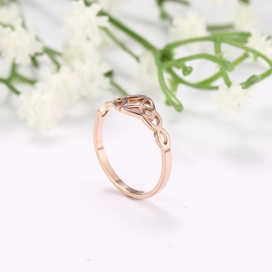Macro shot of rose gold Celtic knot ring with elegant hollow woven infinity design