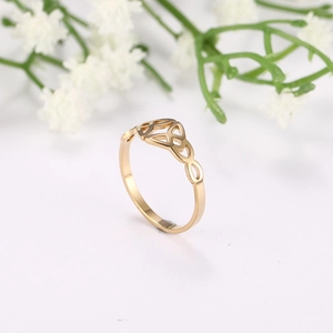 Macro shot of a golden Celtic knot ring with a polished finish and openwork design