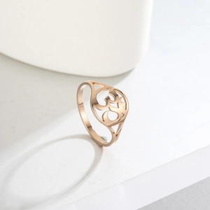 Macro view of rose gold hollow ring featuring the religious Om symbol with polished finish