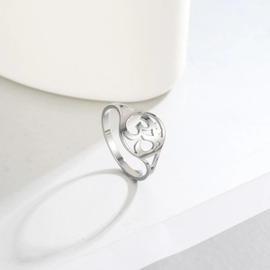 Macro shot of polished silver Om ring showing hollowed circular religious symbol