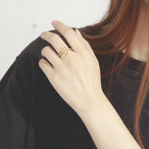 Detailed view of a gold-plated open ring featuring a sacred Om symbol cutout design