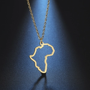 Detail of a minimalist gold African map pendant necklace on a blue textured background